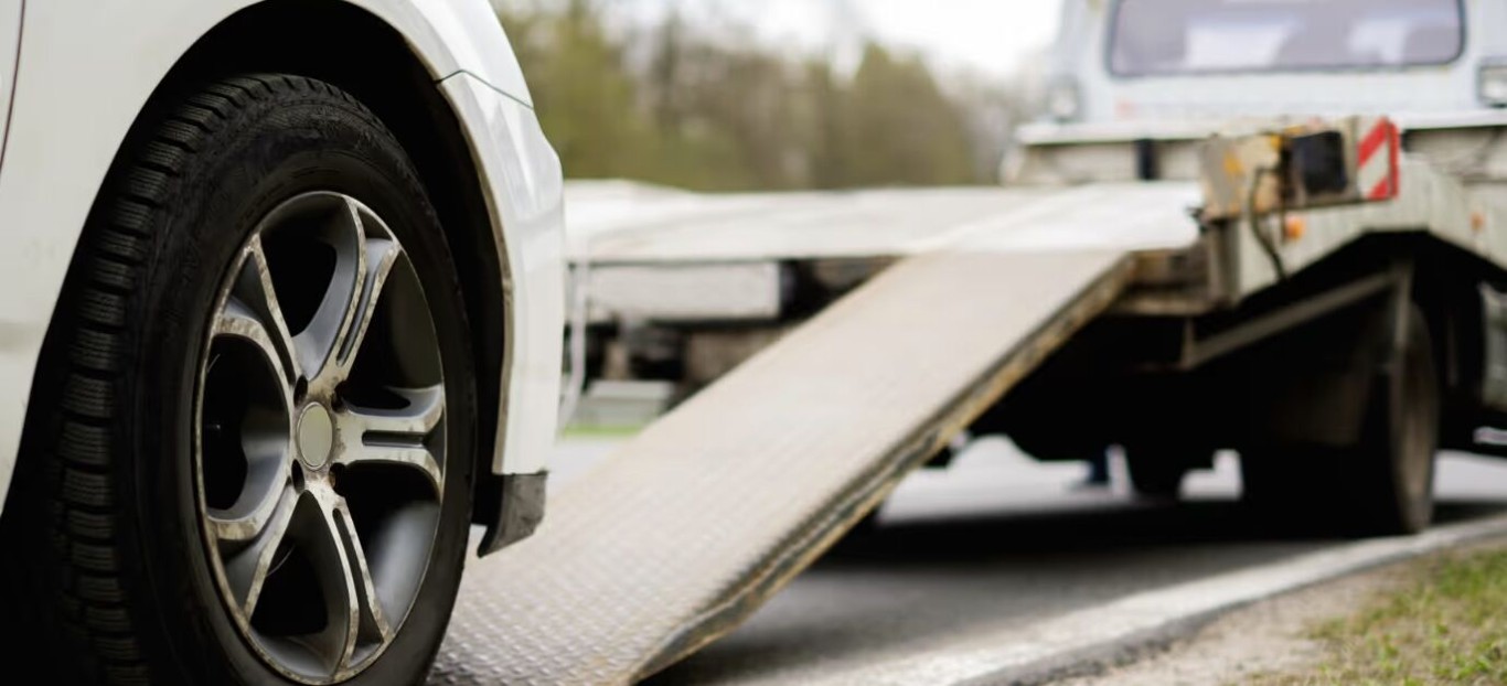 Professional flatbed towing service safely loading a vehicle in Arlington Heights, IL